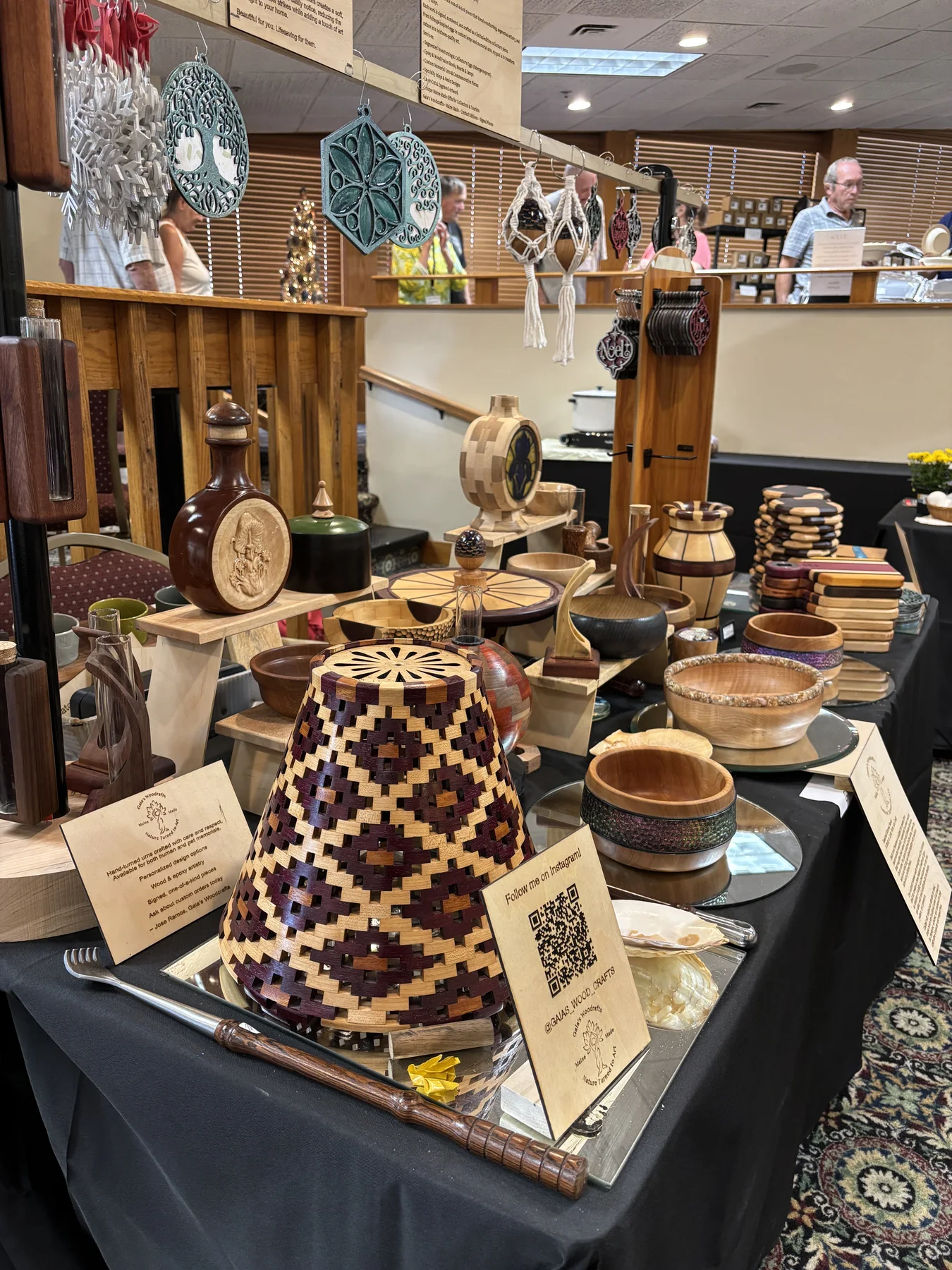 Open-segmented purpleheart, Osage orange, and maple lamp shade displayed among other woodcrafts