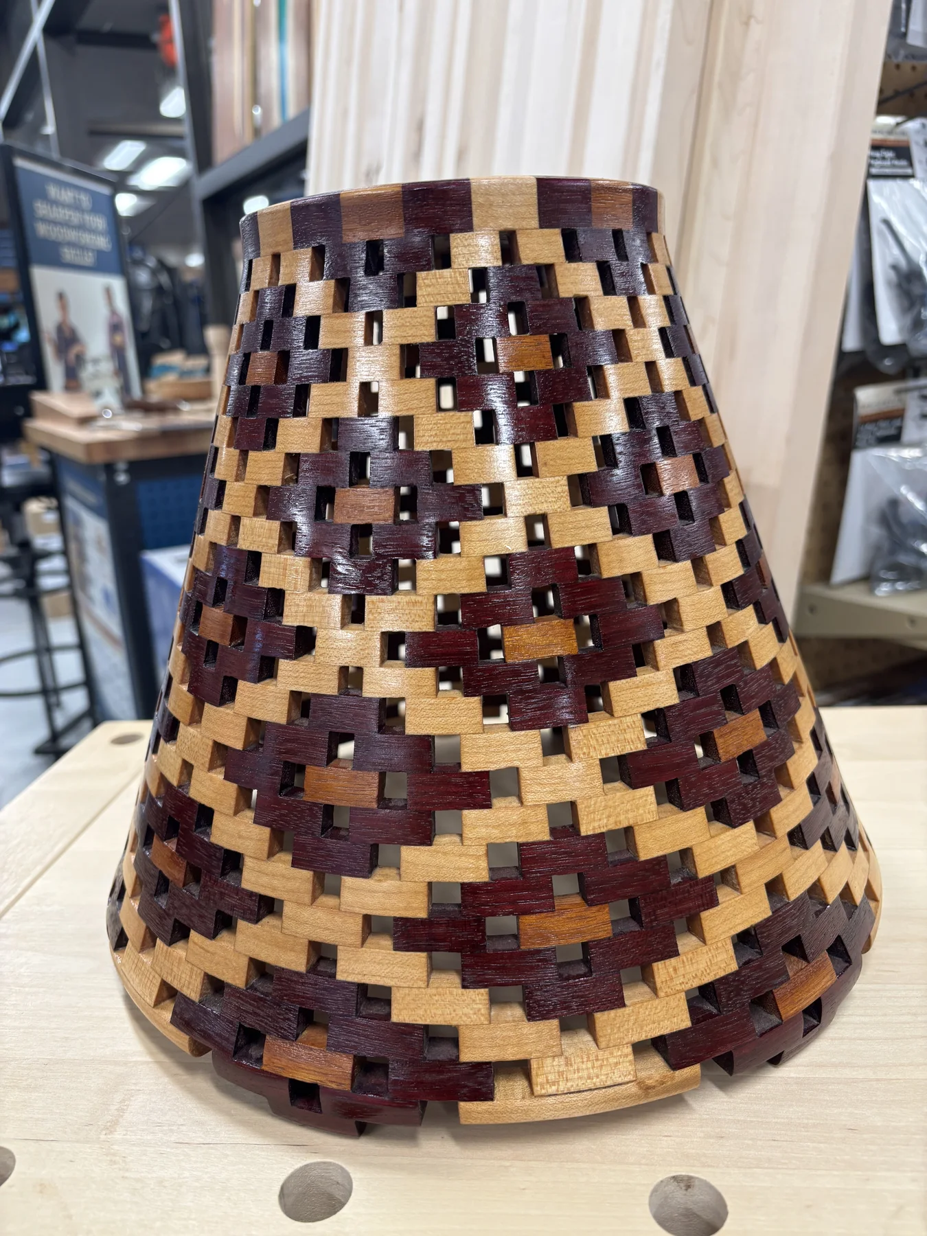 Front view of the open-segmented lamp shade with interwoven purpleheart, Osage orange, and maple