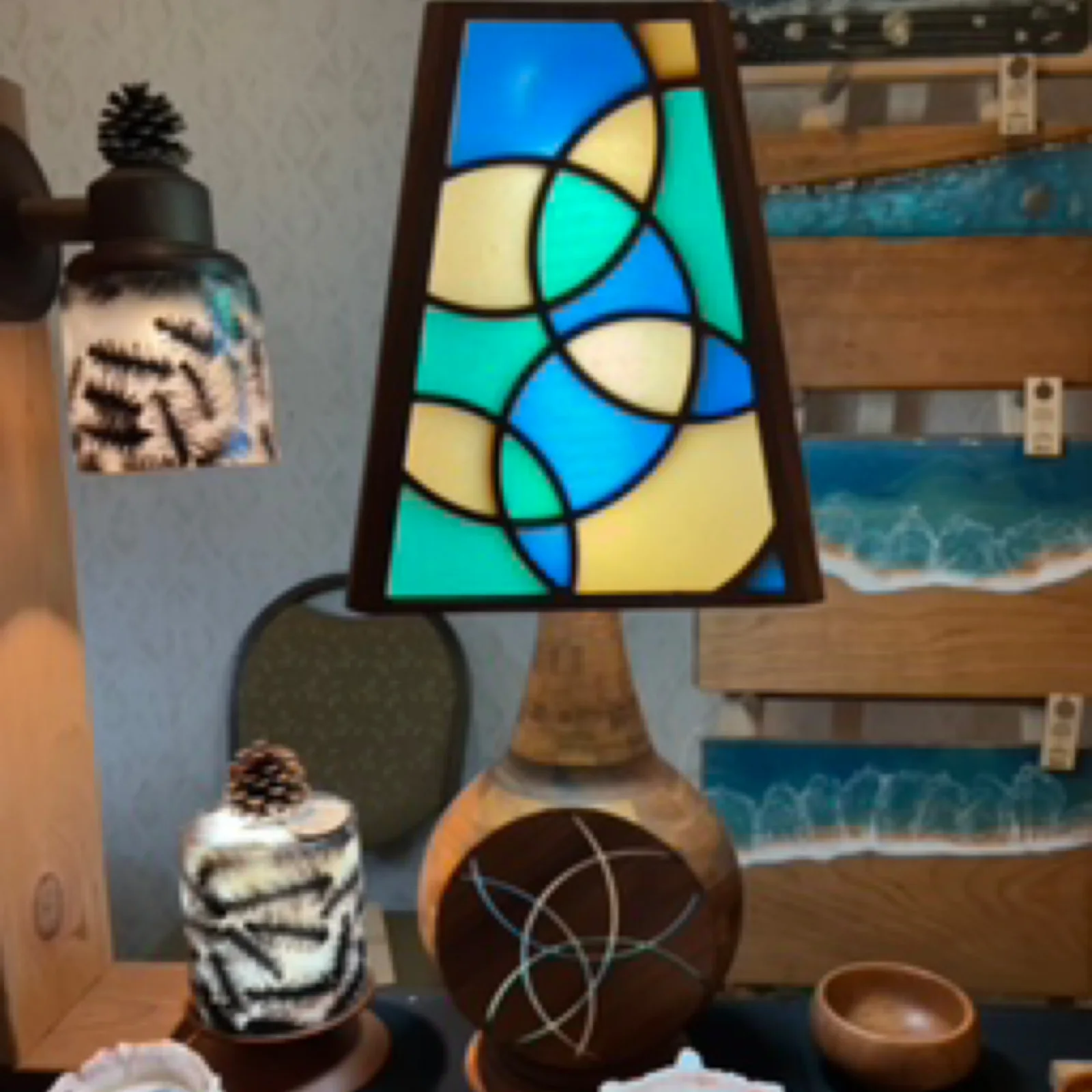 Colorful stained-glass-effect walnut epoxy lamp with a turned wooden base, photographed on display