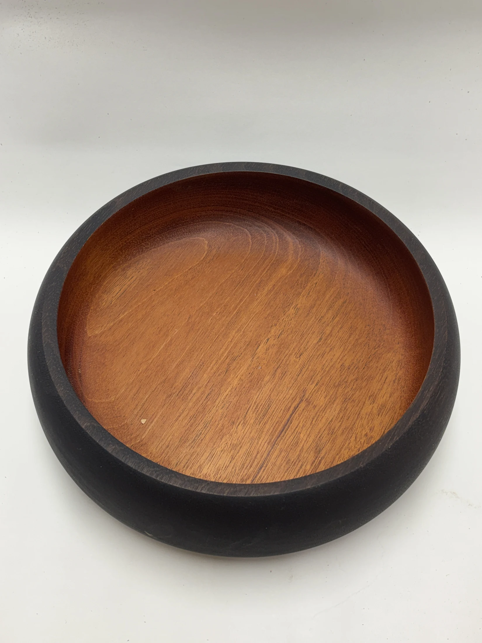 Finished Sapele bowl with a dark ebonized rim and warm natural wood interior