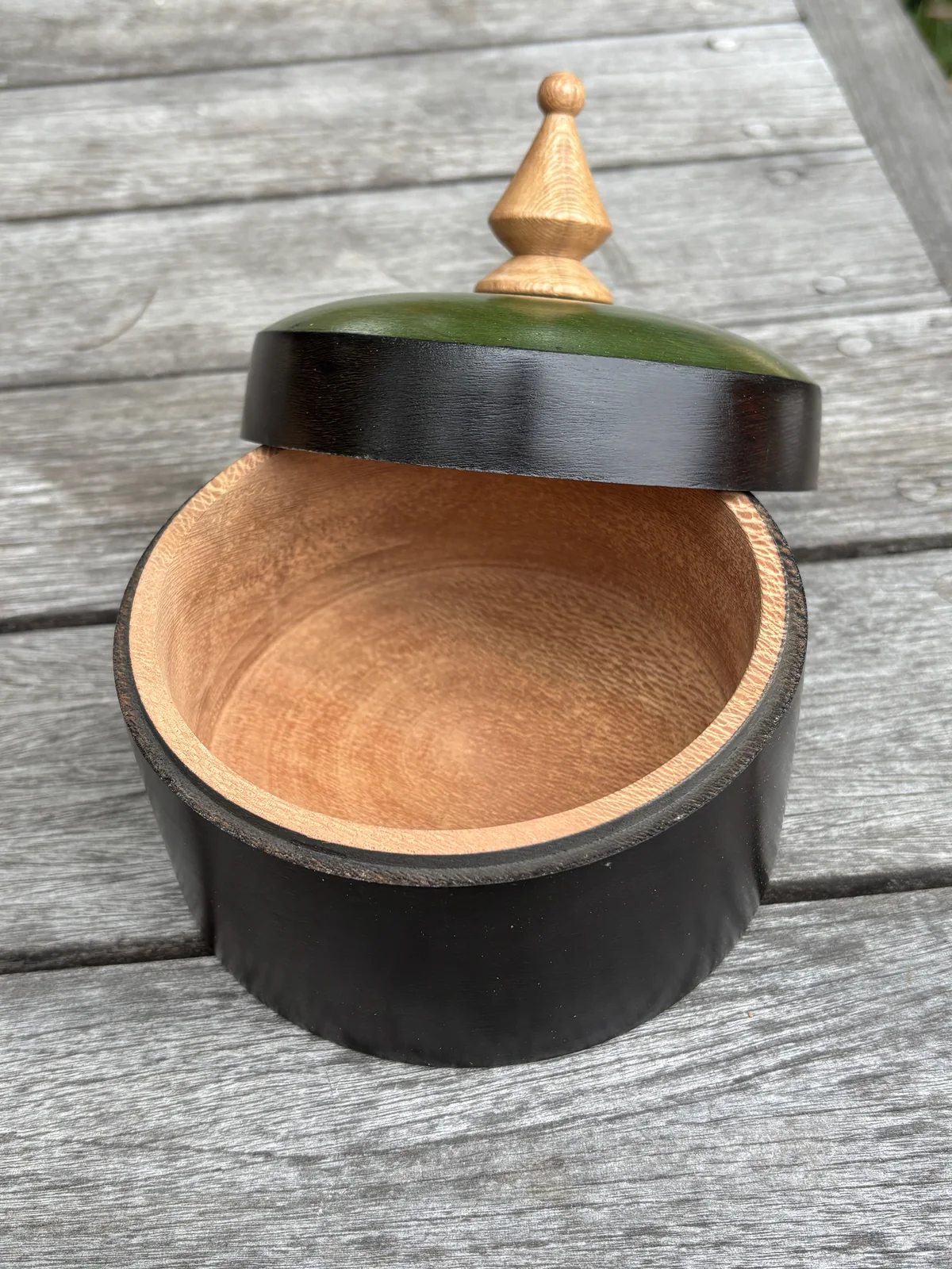 Open ebonized London plane box revealing its warm natural wood interior